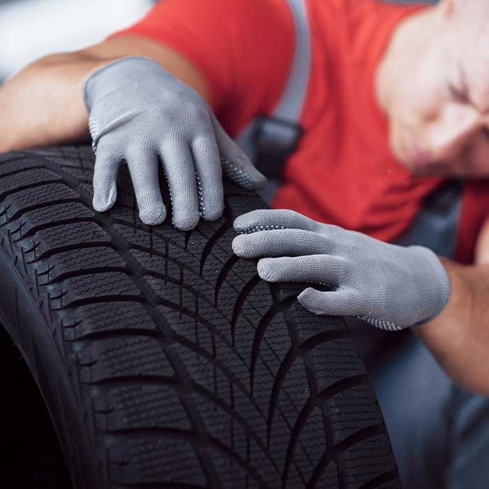 Mechanic holding a tire tire at the repair garage