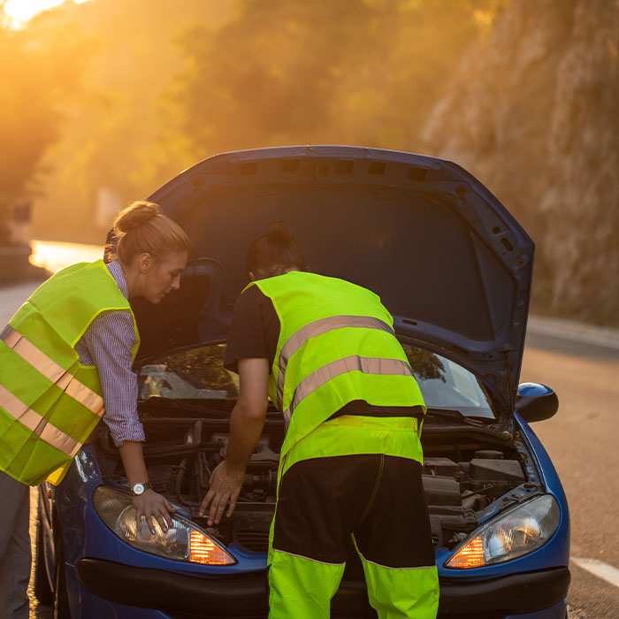 Young woman receiving roadside assistance