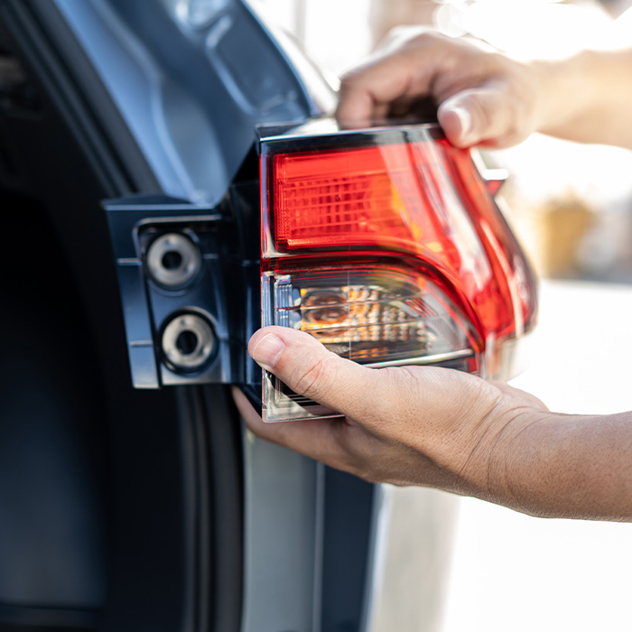 Man changing car tail lights
