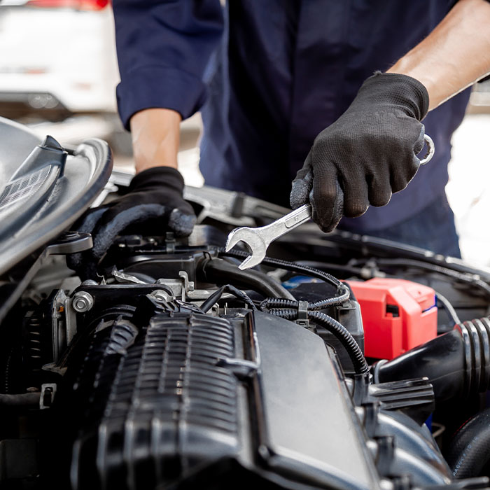 Mechanic using the wrench to repairing change spare part