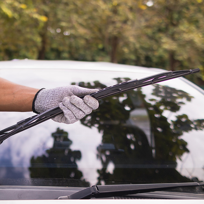 Mechanic checking car wiper blades to replace