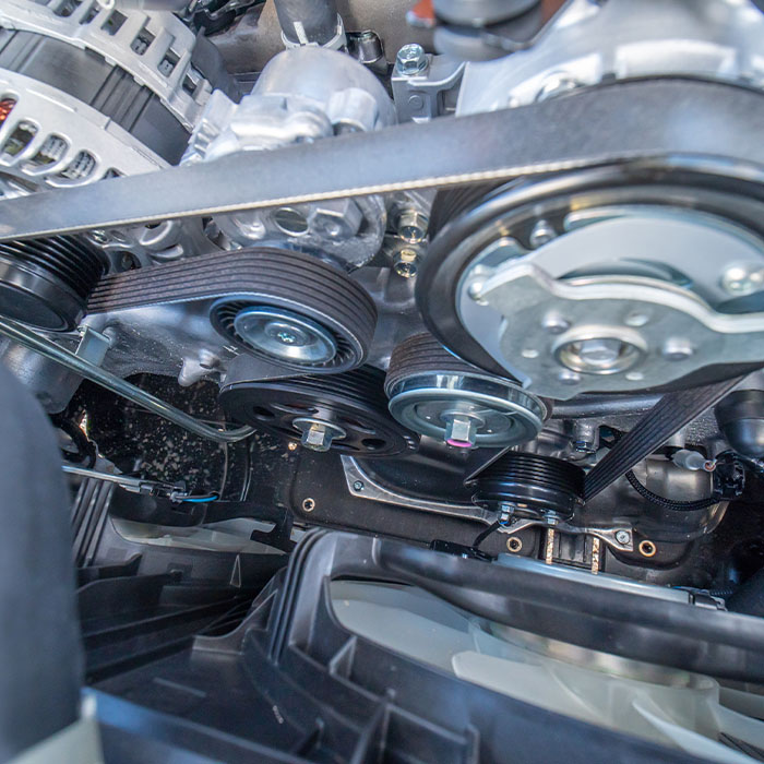 Close up view of engine block timing cover with pulley water pump