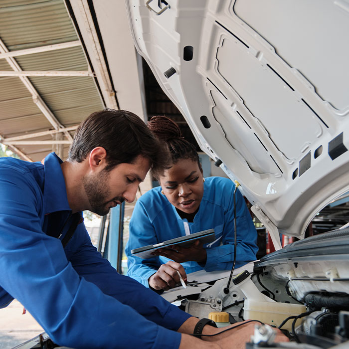 Mechanic workers inspecting service of electric engine