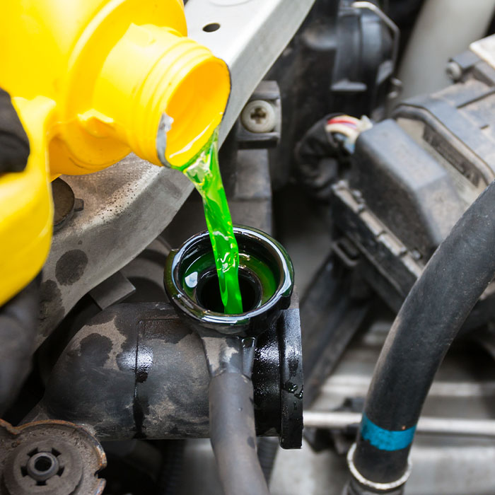 Mechanic pouring coolant
